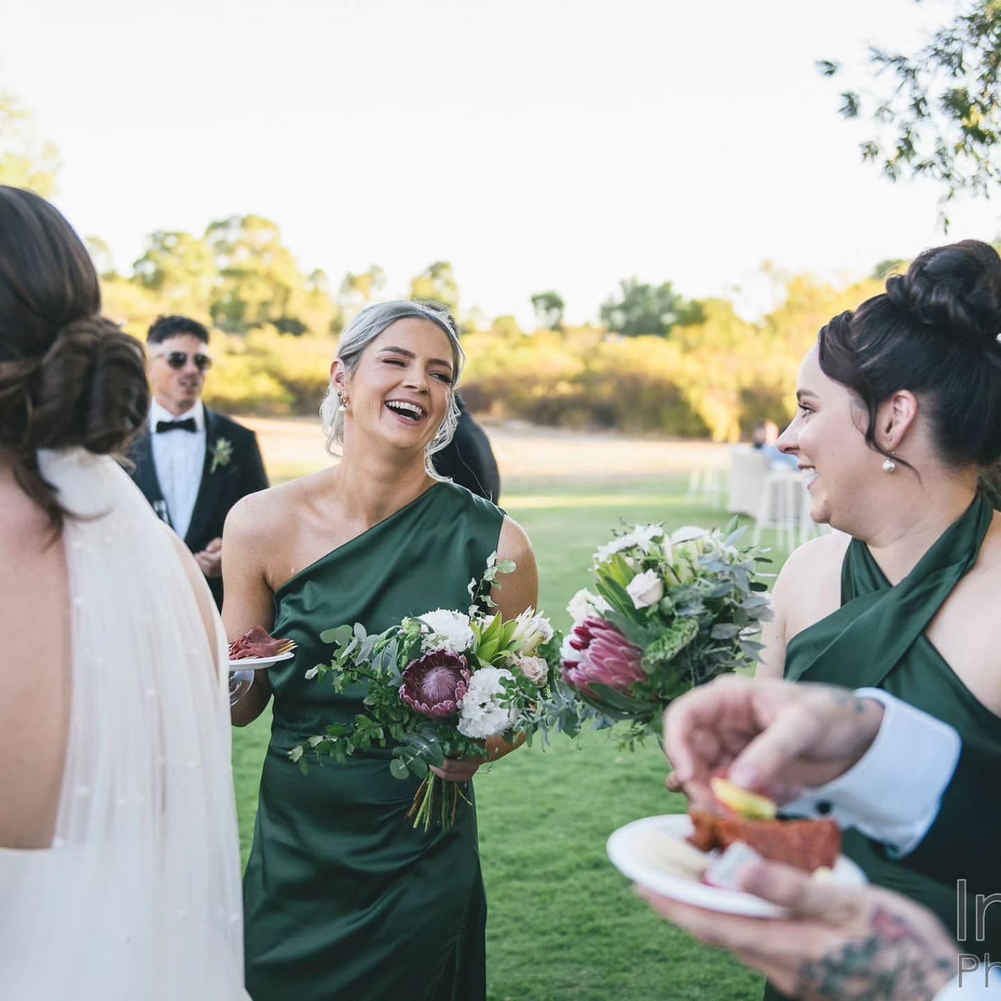 A bridal party in custom made bridesmaid dresses at a Perth wedding