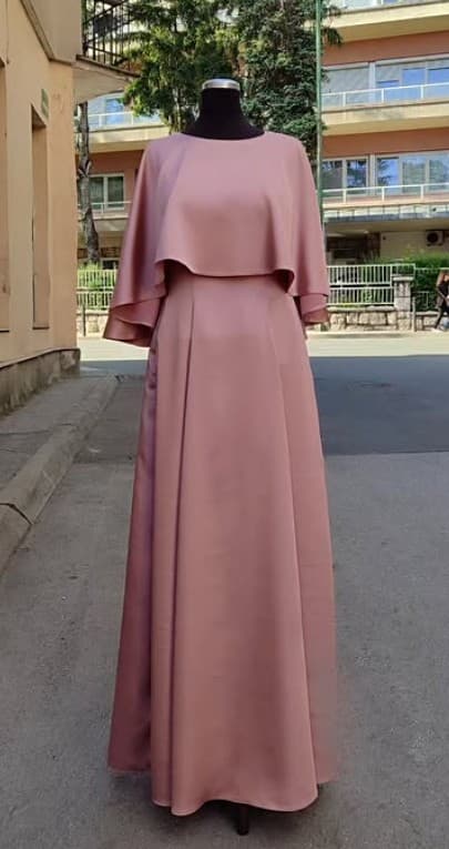 A custom dusty-rose satin gown with a soft capelet overlay