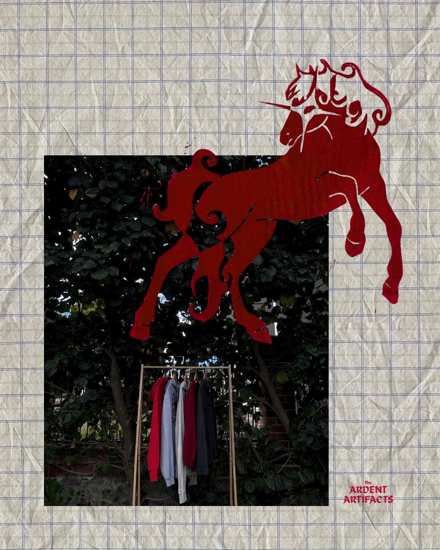 Red unicorn lino print collage over a garden clothing rack
