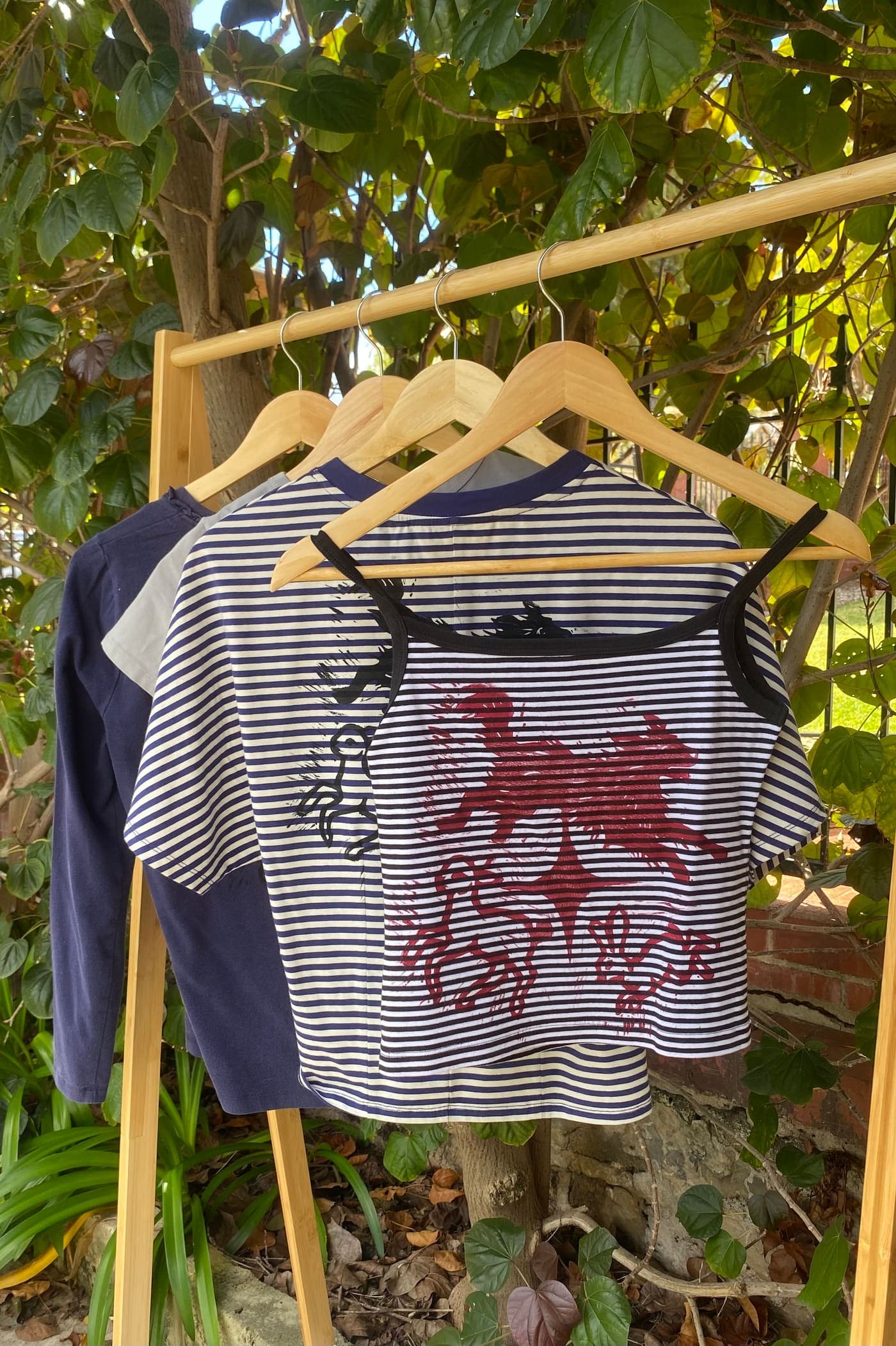 Striped cami with a red lino print hanging in the garden