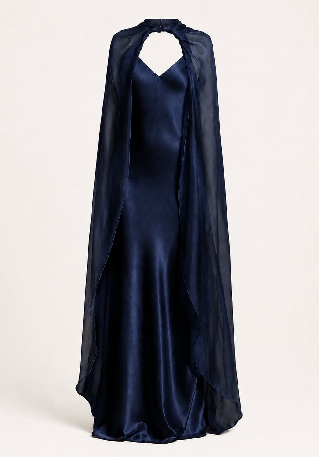 A deep blue silk gown with a floor-length chiffon cape — the cape is the signature element