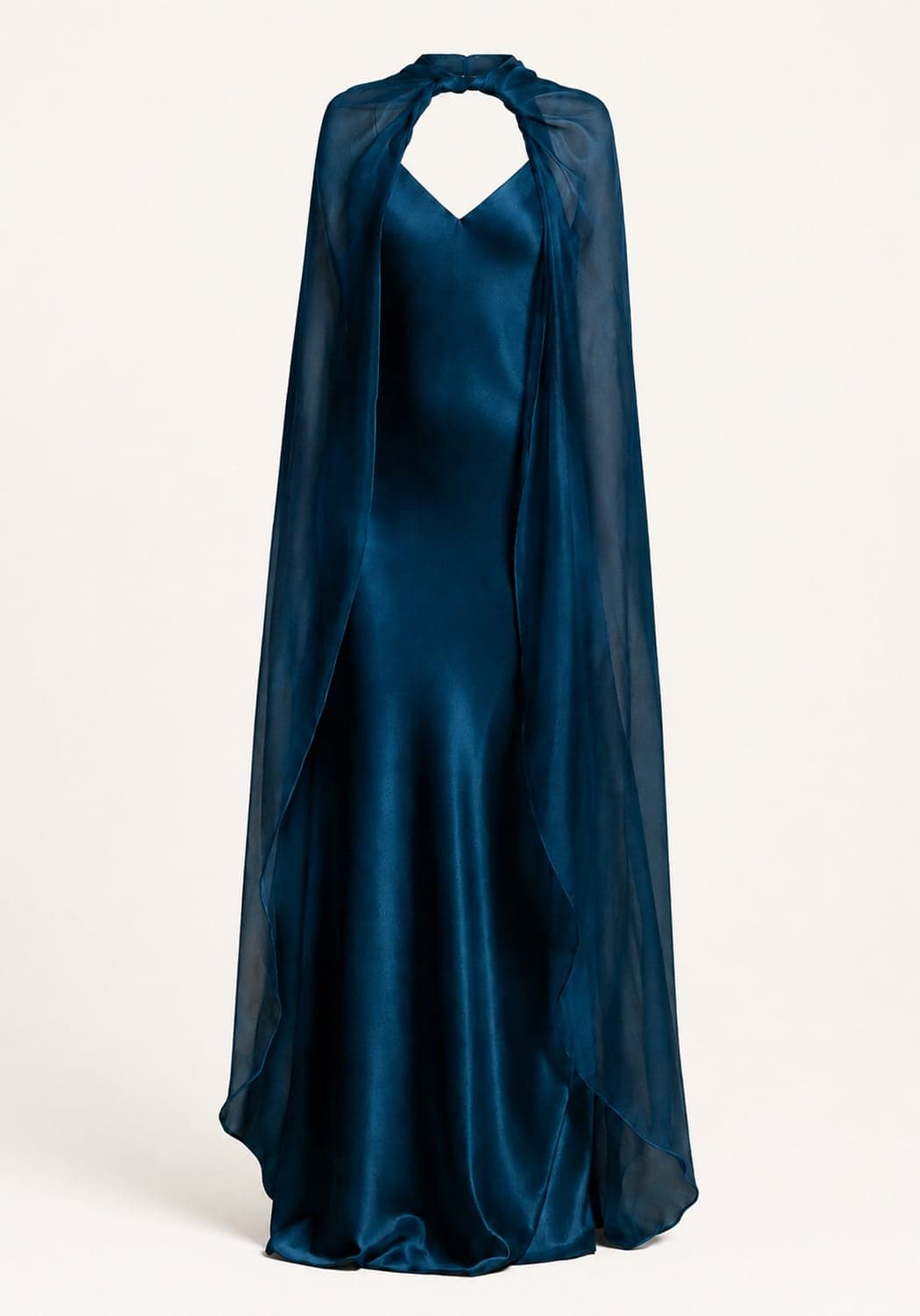 A teal silk gown with a fluid, floor-length skirt, the silhouette doing the work rather than any embellishment