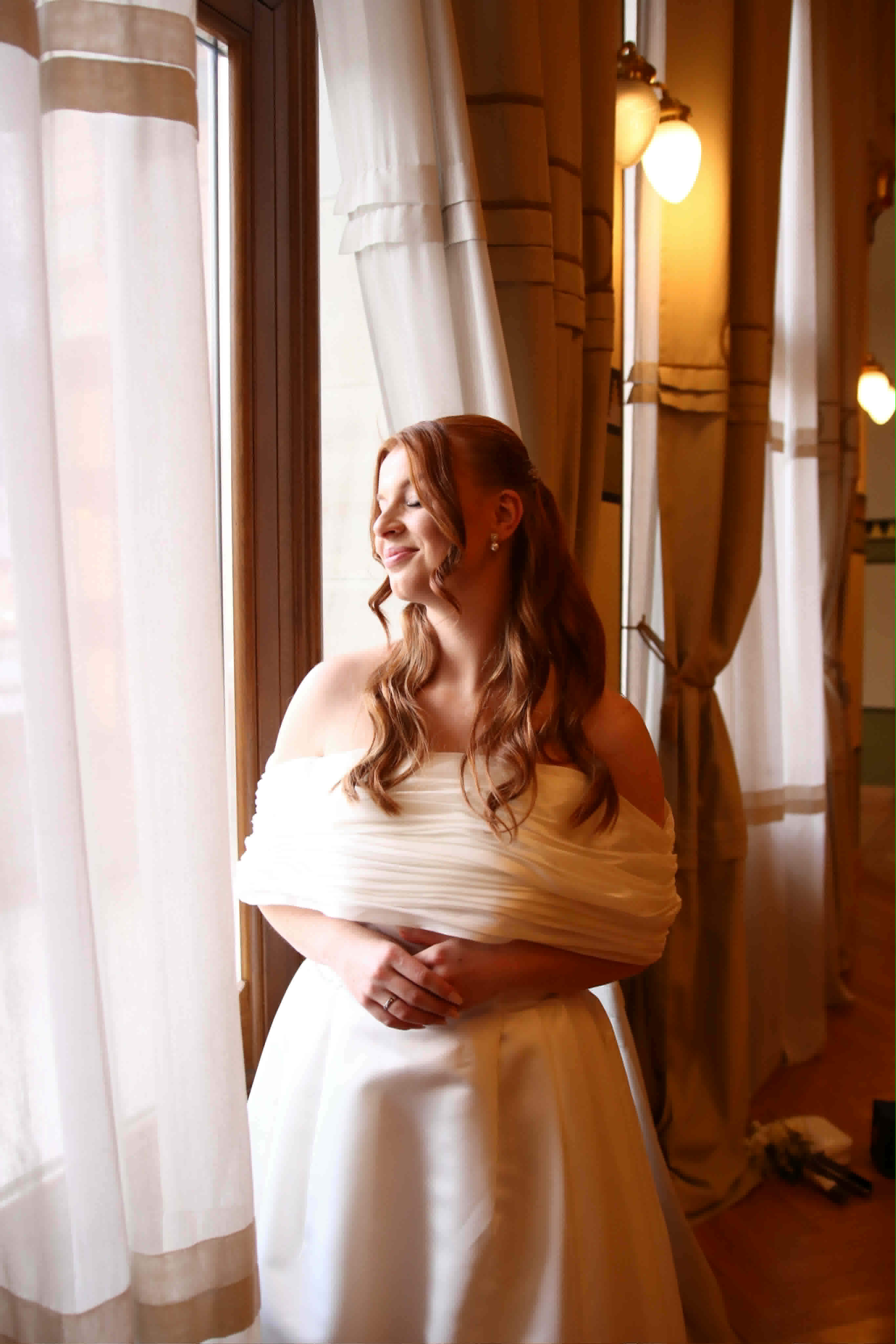 A woman in a custom made off-the-shoulder dress, made to her measurements