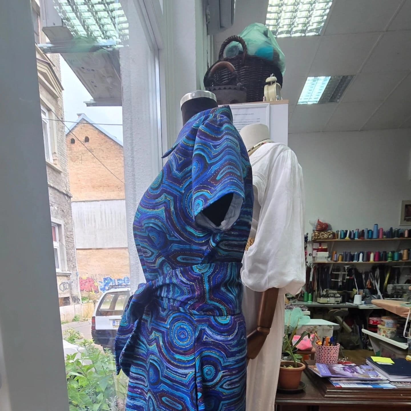 Mary's custom Emu Dreaming shirt dress in the tailor studio before delivery.